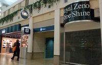 Fig. 122. Color photograph in the airport terminal of an entryway marked “Men,” with a conventional men’s-room symbol, flanked by a shoeshine kiosk and a storefront.