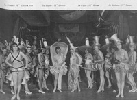 Against the set of a giant automobile, chorus girls appear costumed as car parts.