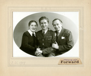 Black-and-white photograph of two parents and their soldier son returned from World War II