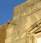 The carving of a muzzled puppy on Duke Bowers's warehouse symbolized his trademark slogan: "You won't get bit if you buy of Mr. Bowers." Photo by author.