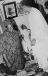 Photograph of Chief Emmanuel Nwanyanwu kneeling down in front of Dr Nnamdi Azikiwe