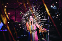 Taylor Mac in an art deco costume with a large mirrored neckpiece inspired by 1920s architecture in a performance of A 24-­Decade History of Popular Music in Brooklyn, New York.
