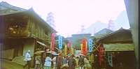 A busy street with colorful calligraphy banners.