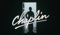 Title screen with English type reading "Chaplin" and underlined across the center of a black and white image of a silhouette of Charlie Chaplin standing in a doorway. The image is mostly black.