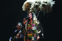 Musician Matt Ray and Taylor Mac wearing a headpiece of giant skulls and a dress of cassette tapes during a performance of A 24-­Decade History of Popular Music in San Francisco, California.