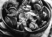 Fig. 69. A ceramic bowl is full to the brim with seafood, including mussels, clams, and squid tentacles.