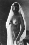 Postcard: Woman in headdress and veil.