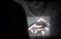 Performances of Iimura Takahiko’s White Calligraphy. On the left, the director writes on a small projected image while the film runs (the character is 命, or “life”). The left hand image shows the theater at the instant the house lights go on, the projector aimed at the screen Iimura painted on during the film’s performance.