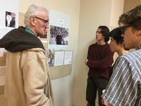 Students and Melrose Residents discuss the images and text on the wall as part of the Boricua College exhibit.