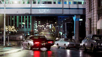 Rainy street scene with lights of traffic