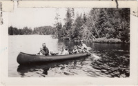 A black-and-white photograph of Joe Seliga and his family paddling a canoe through the water.