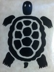 A close up photograph of a black image of a turtle on a white background.
