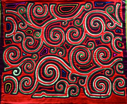 A Guna mola with a red pattern of swirling circles.