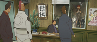 A cartoon scene of people in an office looking at a person standing outside their window, the night cityscape behind them. Calligraphy is visible on the posters in the office.