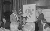 Fig. 22. Photograph of Senators Bob Dole and Chris Dodd presenting a speech report card to President George H. W. Bush.