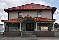 A photo of the front of the West Bosnian Islamic Center building located at 763 Bleecker St, Utica, NY 13501. It looks like other two-story houses in the working-class neighborhood, however, much cleaner and better maintained than most other houses around it. It has a sign clearly identifying it as a “West Bosnian” religious center, distinguishing itself from the general Bosnian Islamic center located less than two miles away on the main street.