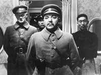 Photograph of Akim Tamiroff wearing a military uniform with Philp Ahn behind him wearing traditional Chinese-­looking clothes
