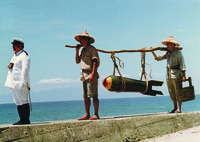 A shot from Strawman showing a policeman leading two men carrying a big, unexploded bomb.