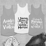 Three tank tops are laid across a herringbone background. The tank on the left says “Avada some Vodka,” the one in the middle “I solemnly swear that I’m getting married,” and the one on the right “My Patronus is wine.” White Converse shoes and a pair of blue jeans lay across the bottom to show how to style the tanks.