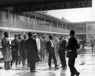 A Birmingham Police Department photograph of Dr. Martin Luther King Jr. (to right of center) talking to his best friend and closest aide Ralph Abernathy at the A. G. Gaston Hotel on Fifth Avenue North in Birmingham. The man to the left of Abernathy, with his back to the camera, appears to be the Rev. Fred Shuttlesworth.