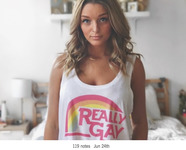 Photo of Kate Austin, a white blond young woman from Austin’s Tumblr page; Kate wears a shirt saying “Really Gay” with a rainbow graphic.