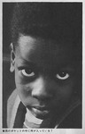 A close-up shot of a little black boy’s face