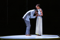 A moment in Jenkins and Leonard’s duet on the satellite stage. Leonard bends at the waist and presses his head into Jenkins’s chest, clasping her hands. Jenkins stands, holding Leonard’s hands, and looks down at him with tenderness.