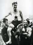 A black-and-white photograph of Francis Amyot being hoisted by teammates.