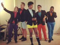 A color photograph of the five members of Every Direction in dragking performance costumes