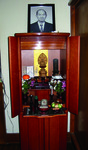 Fig. 16. A photograph of a household altar (butsudan). A memorial portrait (iei) sits prominently on the top of the cabinet, with a memorial tablet (ihai) placed on the top interior shelf on the right.