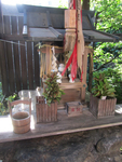 Photograph of a small wooden altar and offerings.