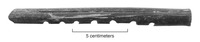 A photo of a broken quena or flute from Structure 12.