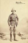 A young Winston Churchill stands in full military garb in front of the Egyptian pyramids. His first name, in signature, appears in the upper right hand corner.