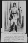 Publicity photo of Habib Benglia, Black Algerian actor while performing title role in The Emperor Jones at the Odéon, Paris, 1923. He wears a light-­colored coat with a gun strapped to his waist.