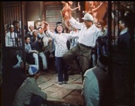 A group of young people dance and sing at a party.