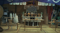 A family shrine is decorated with banners covered with seal script calligraphy. At the center is a rock with "Big" carved in the center. The style is evokes seal script, implying the family's lineage is ancient.