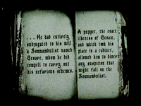 Blurry sepia-toned image of a book with old-looking font that reads "…He had entirely subjugated to his will a Somnambulist named Cesare, whom he did compell to carry out his nafarious schemes. A puppet, the exact likenes of Cesare, and which took his place in a cabinet, allowed him to divert any suspicion that might fall on the Somnambulist."