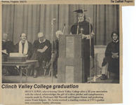 Black and white photograph of Lewis in traditional cap and gown speaking at graduation ceremony shortly before resigning.