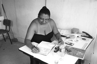 Photograph of Berenice working at a table at Codespa’s headquarters.