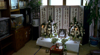 Calligraphic writing on a folding screen at a funeral ceremony
