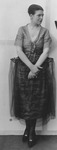 Full-­body portrait of Grace Morse, who appears in a whimsically tailored dress with a boyish, cropped bob.