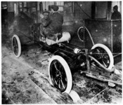 Starting the engine as the chassis leaves the assembly line; Model T, Highland Park Plant, 1914 or 1915