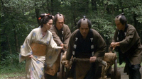 A group of men wear robes with white calligraphy printed on them.