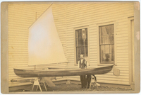 J. H. Rushton poses with his Stella Maris model canoe outside his new boat shop in 1882.
