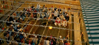 High-­angle shot, as if from “god’s view,” of the dargah courtyard where the qawwali troupe and listeners (all men, most wearing white skullcaps) are gathered during “Kun Faya Kun” in Rockstar.