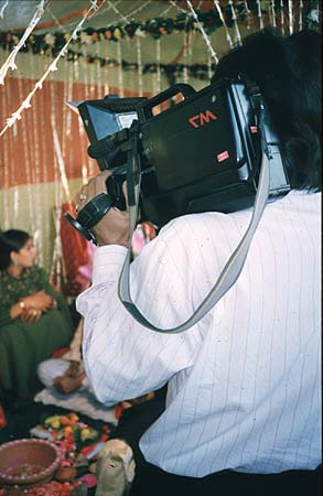 The video camera makes mass marriage into an individual event.